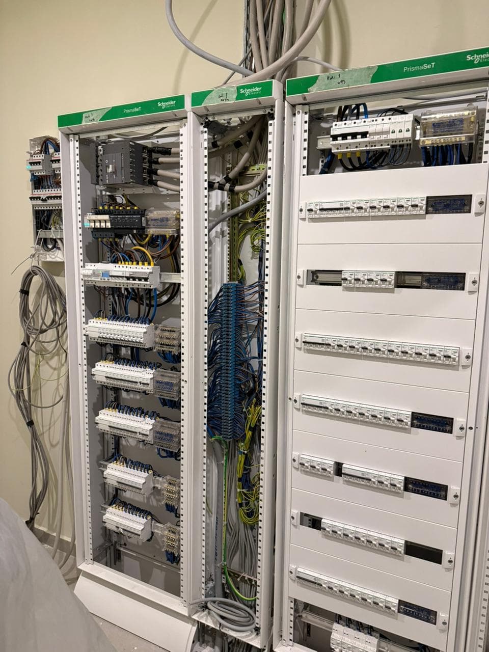 Schneider Electric PrismaSeT electrical control panels with organized rows of circuit breakers and complex wiring.